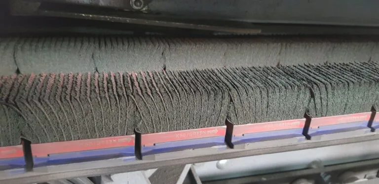 Close-up of a quick-release deburring block mounted on the machine