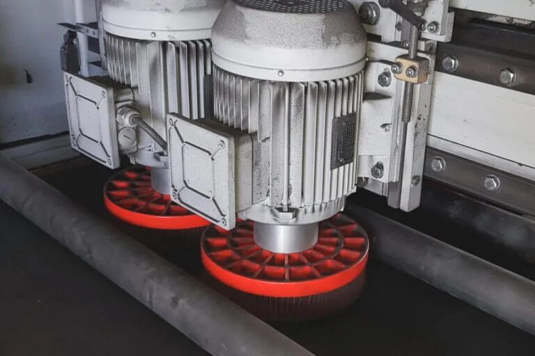 Twin deburring wheel motors inside the Loewer DiscMaster